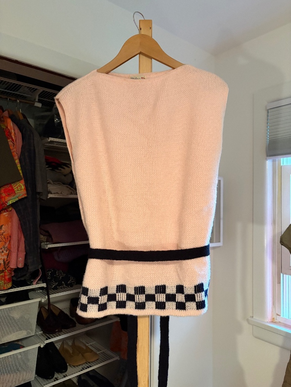 Pale pink and black sweater vest
